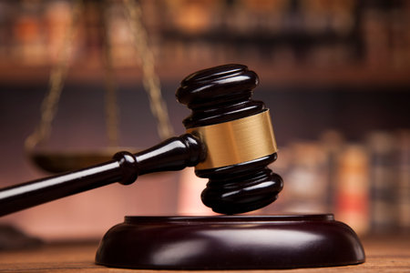 Judge gavel and scales of justice and book background