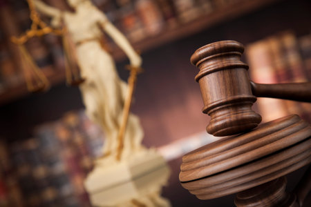Law theme, mallet of the judge, wooden desk, books