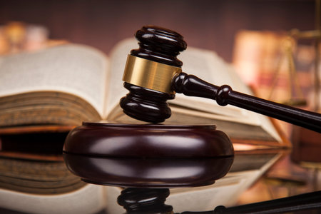 Law theme, mallet of the judge, wooden desk, books