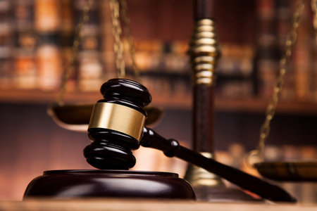 Judge gavel and scales of justice and book background