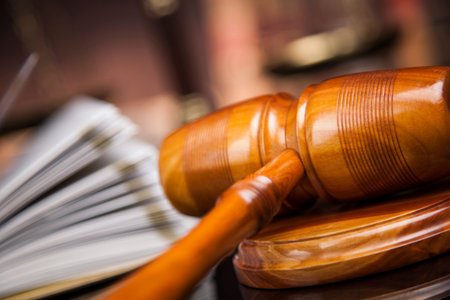 Judge gavel and scales of justice and book background
