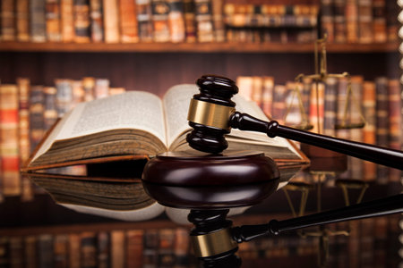 Judge gavel and scales of justice and book background