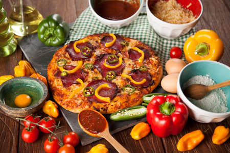 Delicious pizza served on wooden tableの写真素材