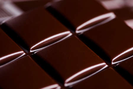 Milk and dark chocolate on a wooden tableの写真素材