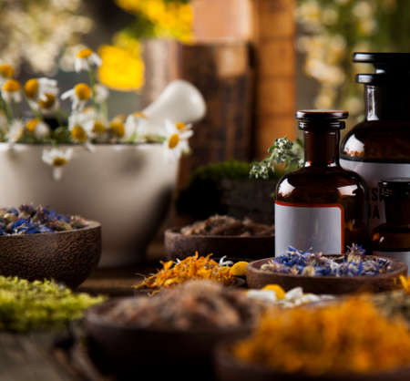 Natural remedy and mortar, healing herbs backgroundの写真素材