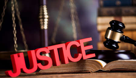 Judges wooden gavel, on wooden table backgroundの写真素材