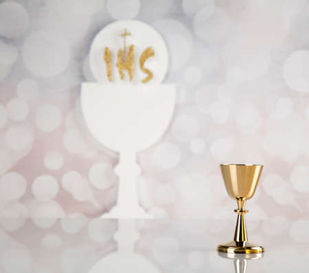 Holy communion a golden chalice, composition isolated on whiteの写真素材