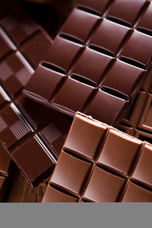 Milk and dark chocolate on a wooden table