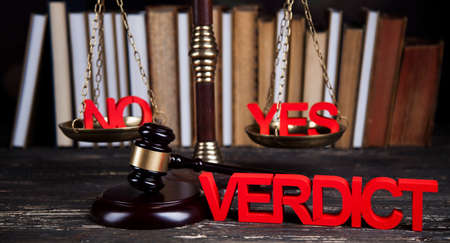 Law theme, mallet of the judge, justice scale, wooden desk backgroundの写真素材