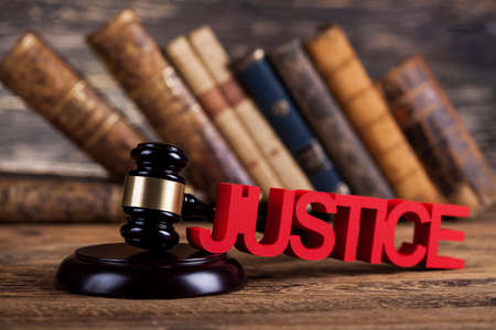 Judges wooden gavel, on wooden table backgroundの写真素材