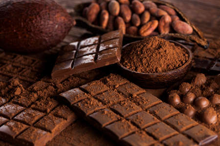 Dark and milk chocolate bar on a wooden tableの写真素材