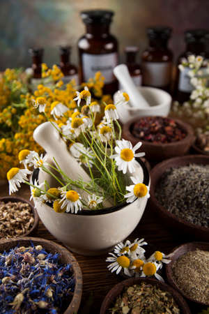 Natural medicine, herbs, mortar on wooden table backgroundの写真素材
