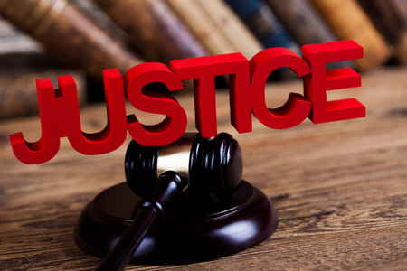 Judges wooden gavel, on wooden table background
