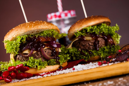 Close-up of home made burgers, wooden desk backgroundの写真素材