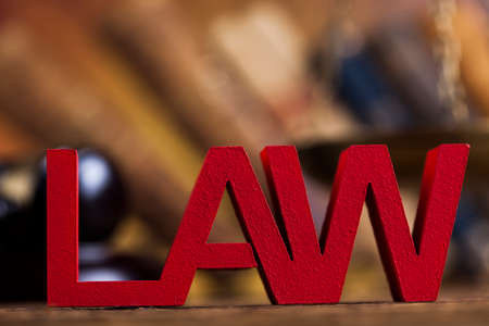 Law theme, mallet of the judge, justice scale, wooden desk backgroundの写真素材