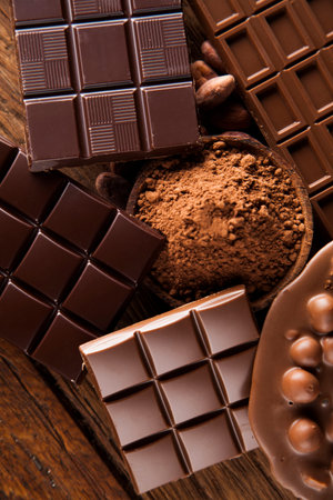 Aromatic cocoa and chocolate on wooden background