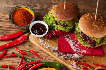 Fast food hamburge, wooden desk backgroundの写真素材