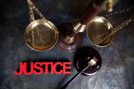 Judges wooden gavel, on wooden table backgroundの写真素材