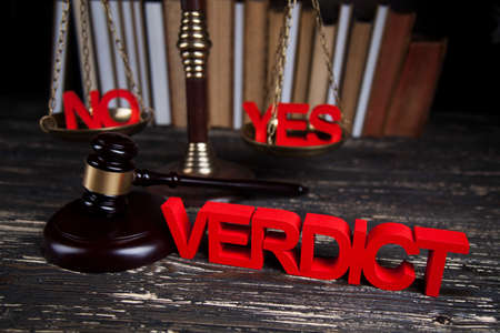 Law theme, mallet of the judge, justice scale, wooden desk backgroundの写真素材