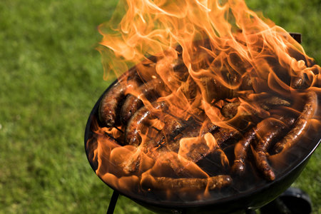 Grill with red hot briquettes, fire backgroundの写真素材