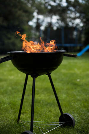 Barbecue grill with fire on nature, outdoor, close upの写真素材