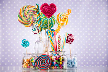 Colorful lollipops and different colored round candy and gum ballsの写真素材