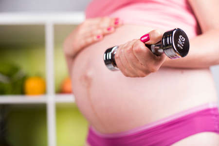 Pregnancy, sport, fitness, healthy lifestyle conceptの写真素材
