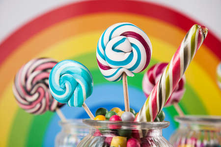 Glass jars in Colorful candies,lollipops and gum ballsの写真素材