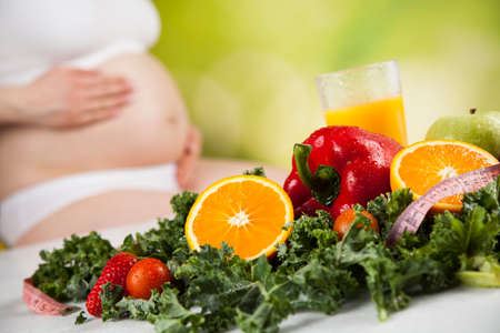 Pregnant woman with fruit and vegetablesの写真素材