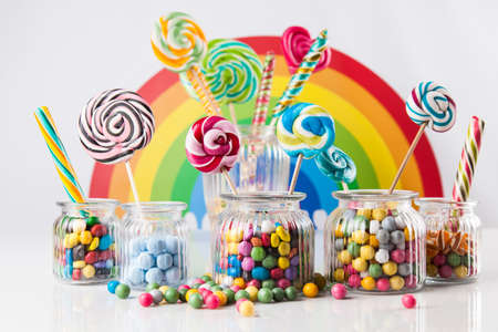 Colorful lollipops and different colored round candy and gum ballsの写真素材