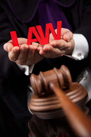 Judge, male judge in a courtroom striking the gavelの写真素材