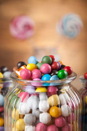Colorful lollipops and different colored round candy and gum balls