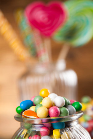 Colorful lollipops and different colored round candy and gum balls