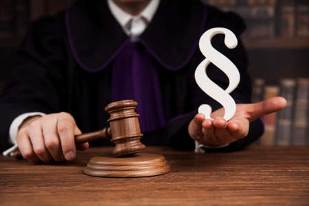 Justice and law concept, Male judge in a courtroom striking the gavelの写真素材