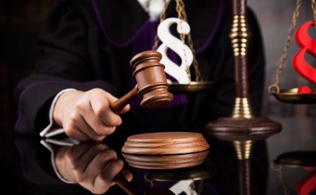 Judge, male judge in a courtroom striking the gavelの写真素材