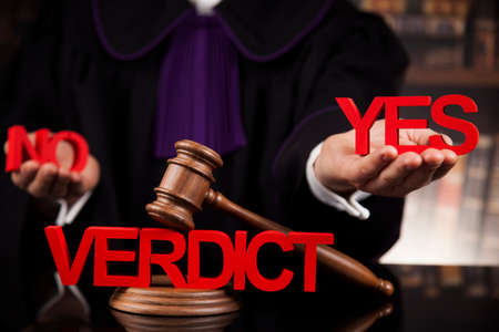 Male judge in a courtroom striking the gavelの写真素材