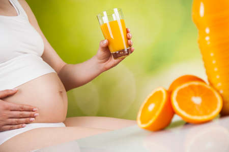 Pregnancy, healthy food and people conceptの写真素材