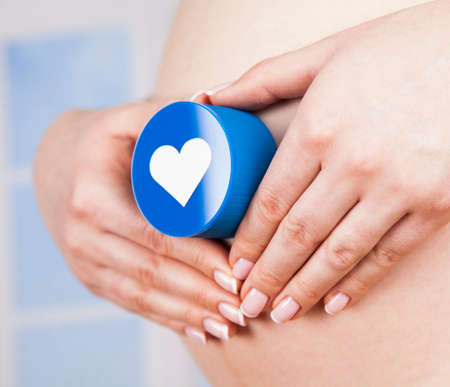 Pregnant woman holding a heartの写真素材