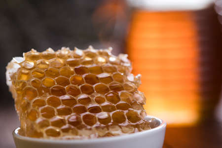 Jar full of fresh honey and honeycombsの写真素材