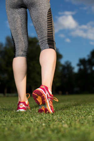 Runner feet running on road closeup on shoeの写真素材
