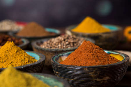Spices and herbs in wooden bowls. Food and cuisine ingredientsの写真素材