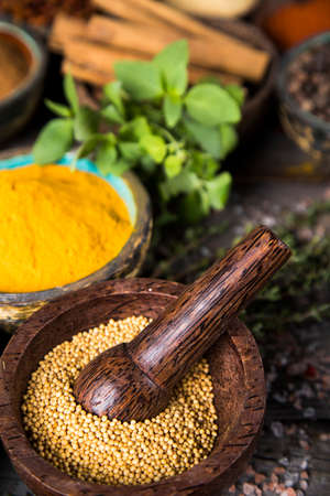 Wooden table of colorful spicesの写真素材