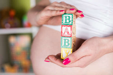 Wooden toy cubes with letters, Baby, Pregnancy conceptの写真素材