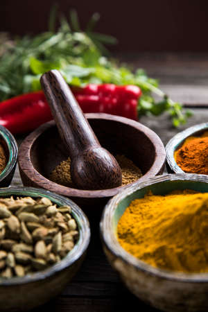 Wooden table of colorful spicesの写真素材