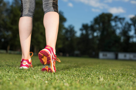 Runner feet running on road closeup on shoe