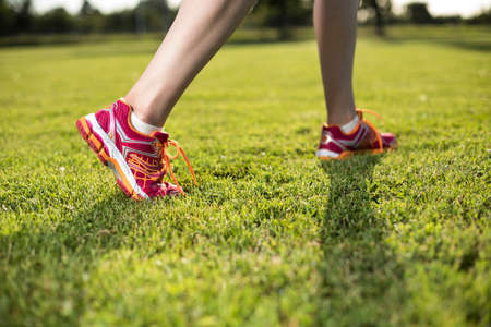 Runner feet running on road closeup on shoeの写真素材