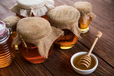 Fresh honey on wooden tableの写真素材