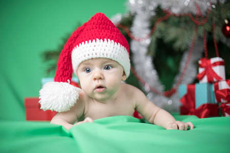 Little cute baby girl with santa hatの写真素材