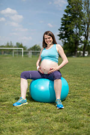 Pregnancy, sport, fitness, people and healthy lifestyle conceptの写真素材