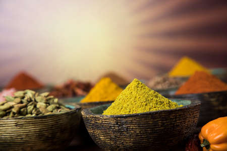 Wooden table of colorful spicesの写真素材